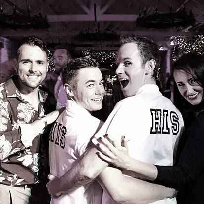 A happy couple celebrating with members of House Party