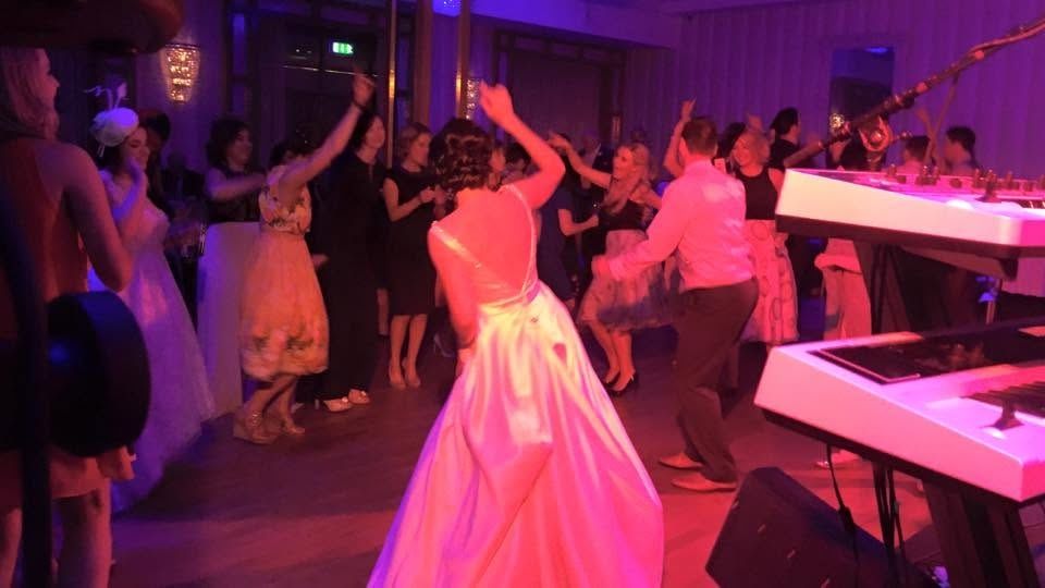 A bride dancing on a packed dance floor
